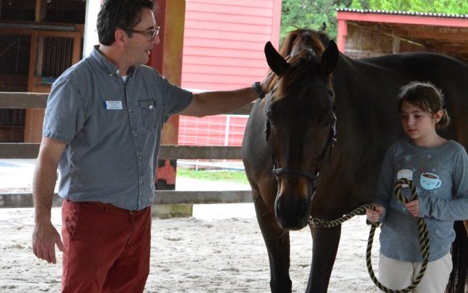 Craig Price and participant Kenzie Evans during an Equine-Assisted Improv Therapy session at The Naples Therapeutic Riding Center