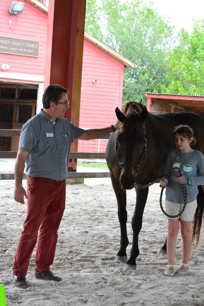 Craig Price and participant Kenzie Evans during an Equine-Assisted Improv Therapy session at The Naples Therapeutic Riding Center